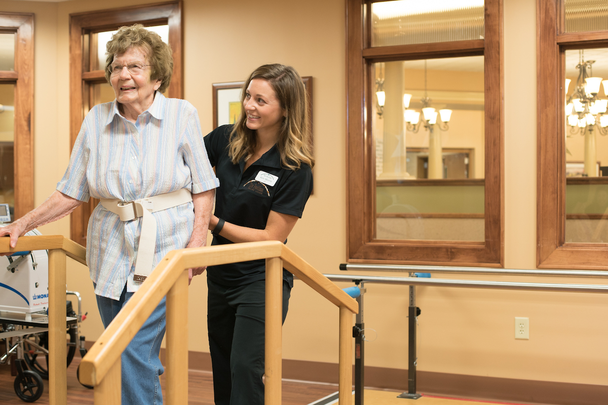 The Pavilion Senior Living_Senior Woman Walks with Assistance from Caregiver